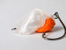 SandSpawn Pompano Sushi artificial sand flea lure in pearl and orange with hook on a white background.