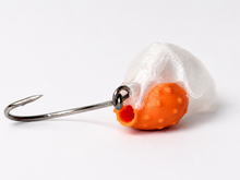 Rear view of the SandSpawn Pompano Sushi artificial sand flea lure showing the scent chamber opening and hook on a white background.